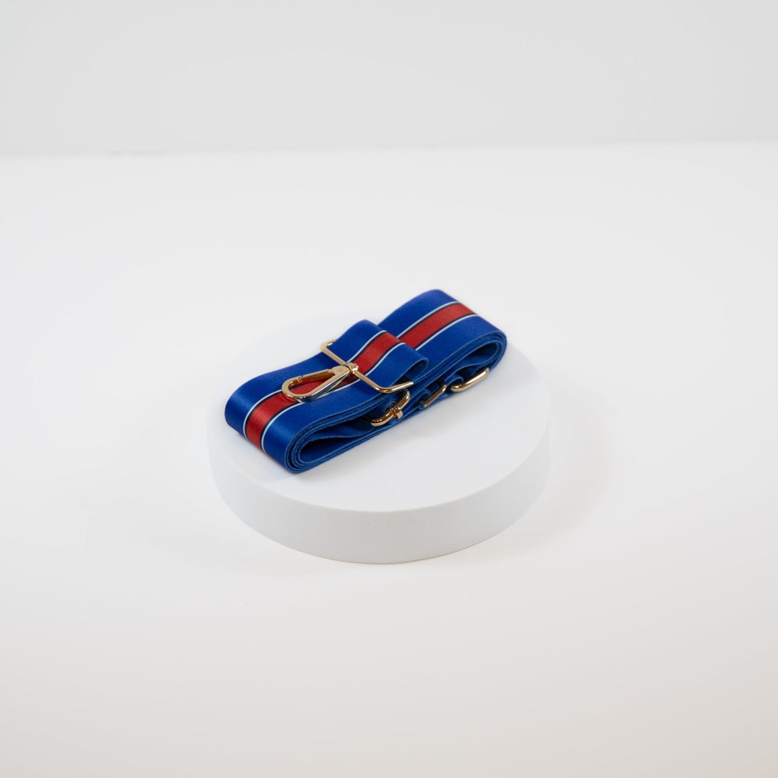 Elegant crossbody strap shown in Buffalo Bills team colors of blue and red.