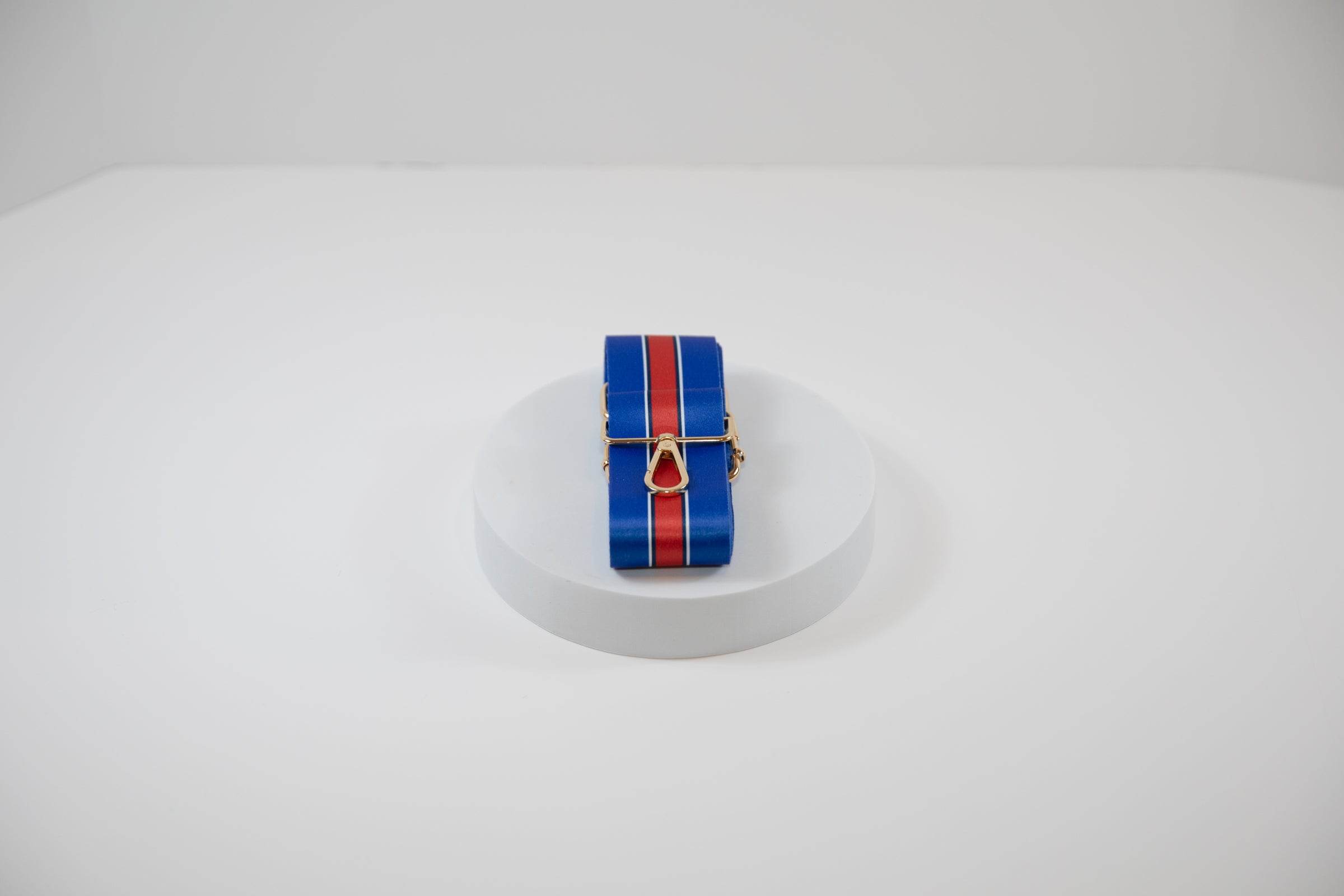 Elegant crossbody strap shown in Buffalo Bills team colors of blue and red.