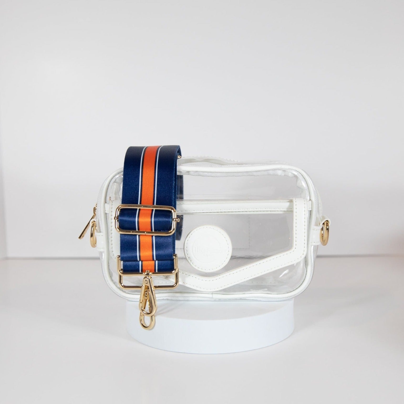 Clear stadium bag with white leather trim, front facing, with a crossbody strap in Denver Broncos colors.