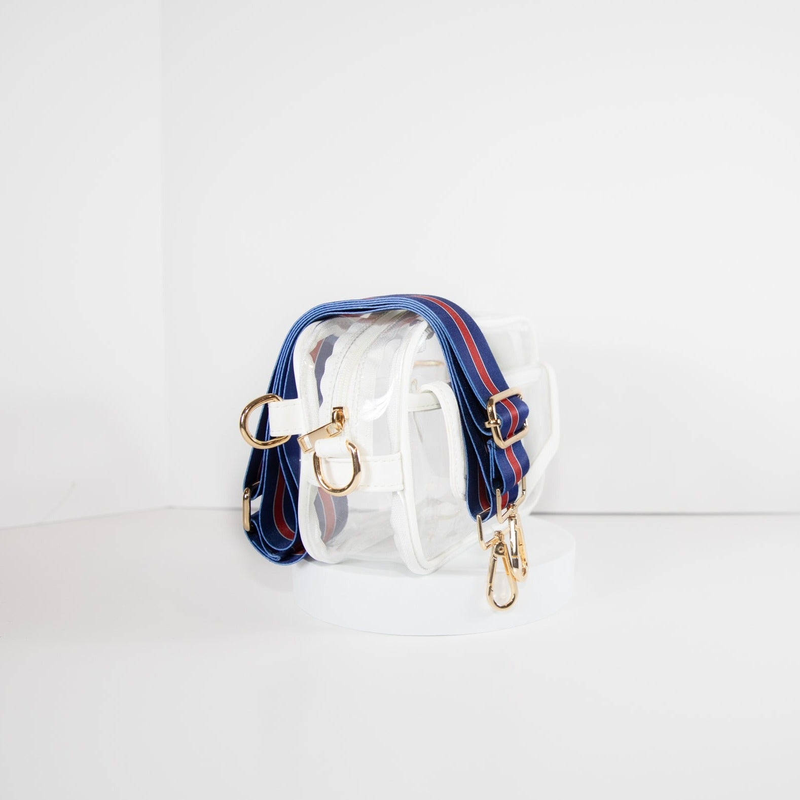 Clear Stadium Bag with white leather trim, side facing, with a crossbody strap in the colors of the New York Giants.