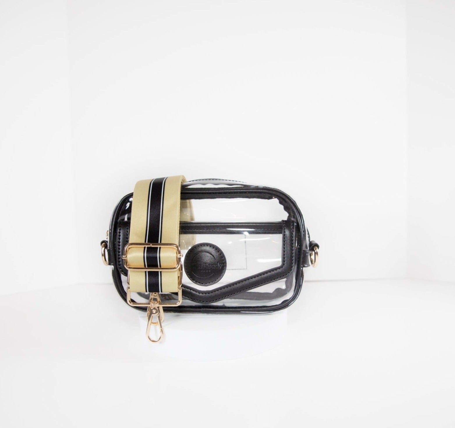 Clear stadium bag with black leather trim, front facing, with a crossbody strap in colors of New Orleans Saints.