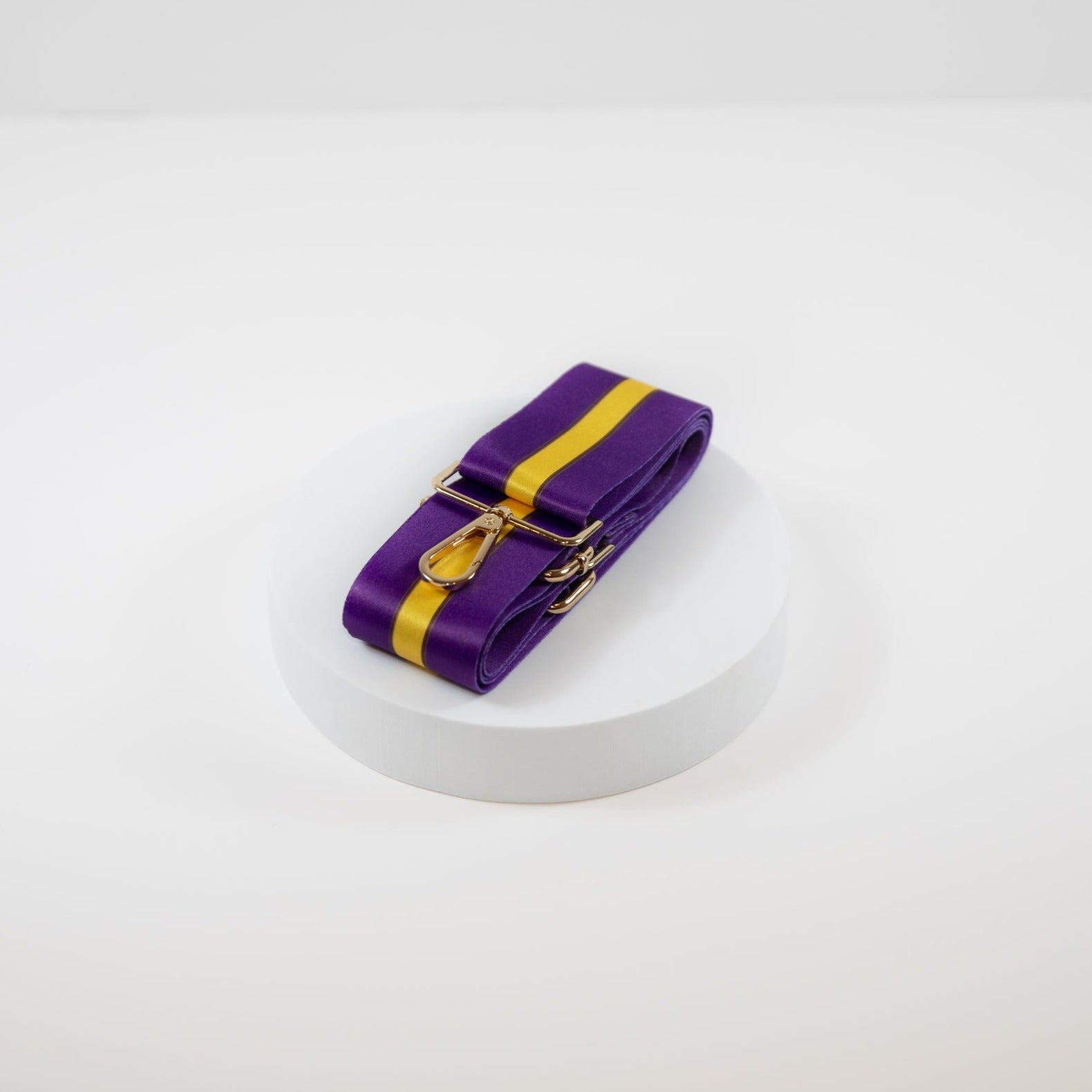 Elegant crossbody strap shown in LSU Tigers team colors of purple and gold.